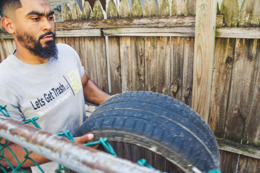 man carrying a tire